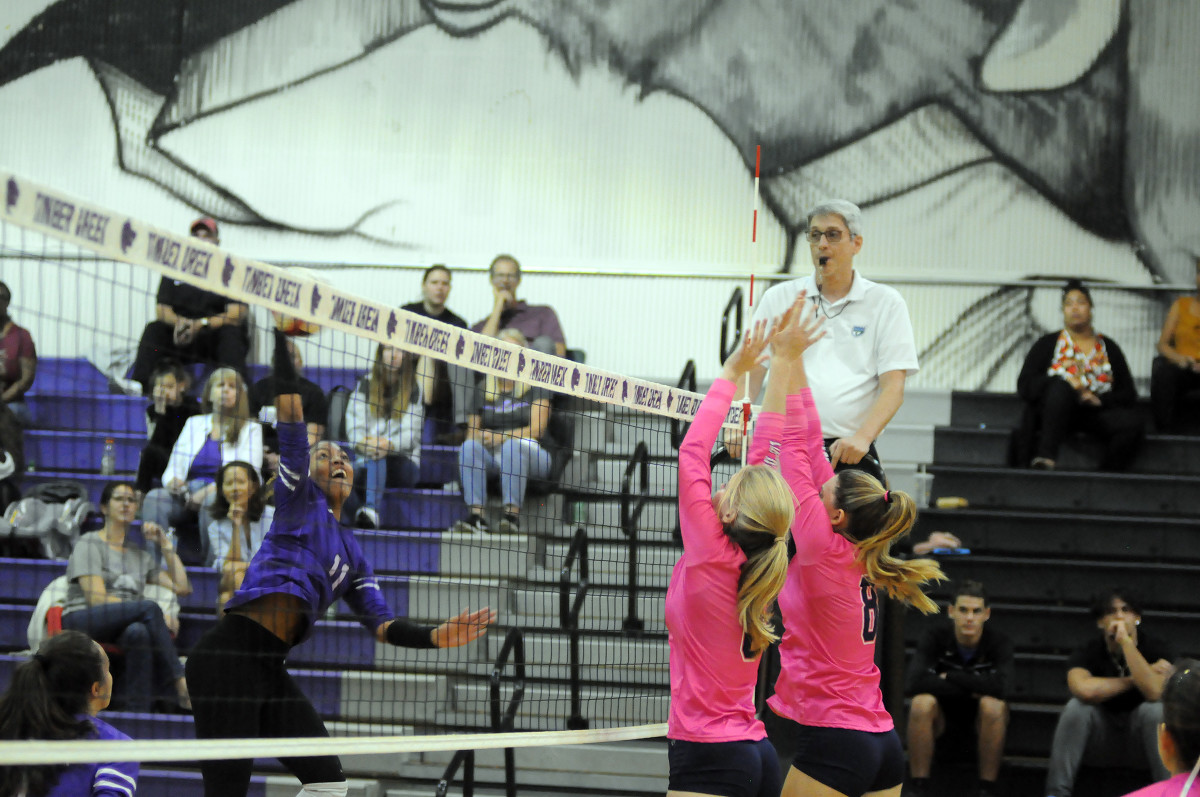 Timber Creek's Jayda Redd goes for a kill against Lake Nona blockers Reagan McConomy (6) and Ella McDonald (8) during their match Wednesday. Redd had 16 kills, while McConomy and McDonald each had two blocks.